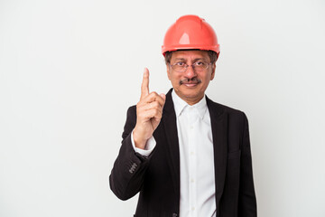 Middle aged indian architect man isolated on white background showing number one with finger.