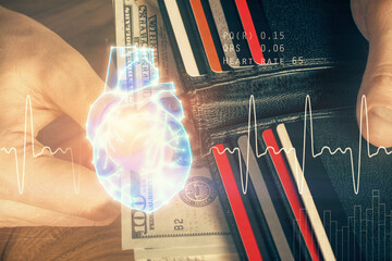 Multi exposure of heart drawing hologram and USA dollars bills and man hands. Medical education