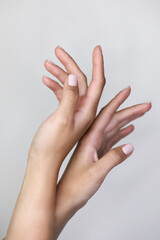 beautiful hands with manicured nude nails manicure.
