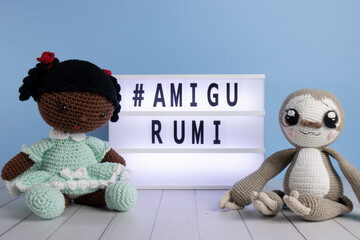 Amigurumi Girl and Sloth with a  
luminous plate. Crochet hand made girl and sloth.