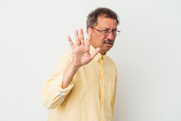 Middle aged indian man isolated on white background rejecting someone showing a gesture of disgust.