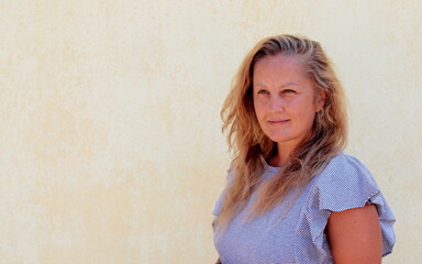 Fototapeta premium portrait of a pretty woman of 40 years with blonde hair of European appearance.