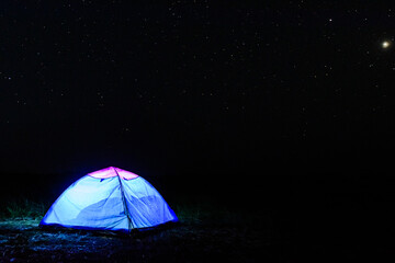 Tourist tent at night. Night sky with the many stars