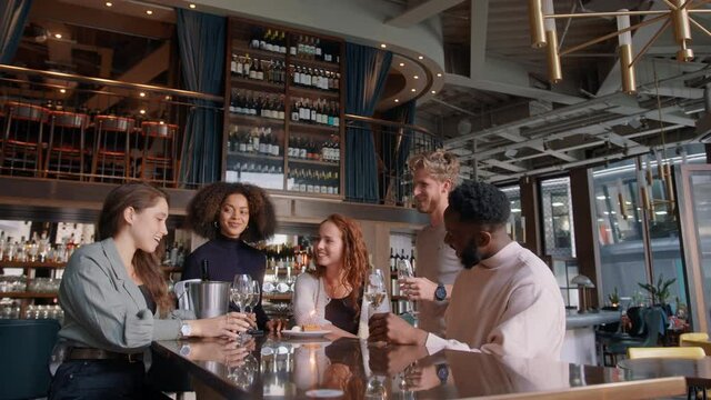 Slow motion of friends celebrating birthday in bar