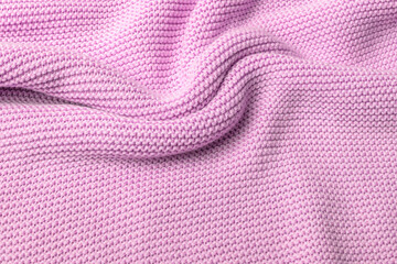 Pink knitted fabric background. Purl loops close-up. Crumpled curved surface