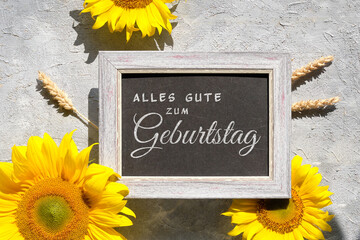 Text Alles Gute zum Geburtstag means Happy Birthday in German language. Yellow sunflower flowers...
