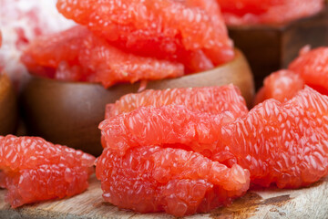 peeled red grapefruit divided into slices