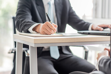 business man write on notebook in office
