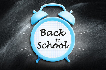 one blue alarm clock on school blackboard background, concept back to school
