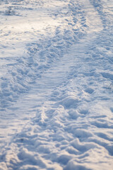 Winter snowy road through the fields 