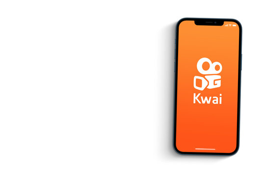 Kwai app on smartphone screen on orange background. Social media