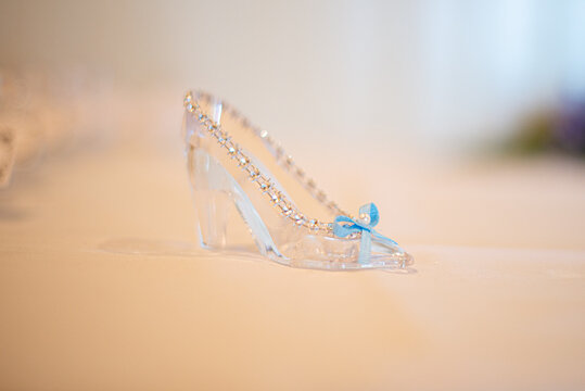 Miniature cinderella's glass slipper with blue bow cake topper