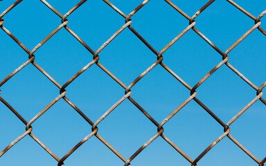 Fototapeta premium chainlink fence on blue sky
