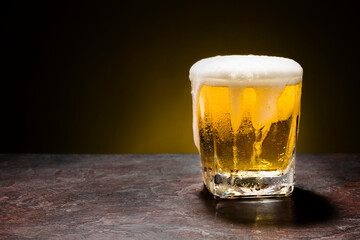 beer glass on dark black background with copyspace
