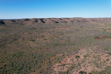 Outback Australia aerial drone photo over the wild rugged limestone mountain ranges and dry desert landscape of Cape Range National Park, Ningaloo Coast
