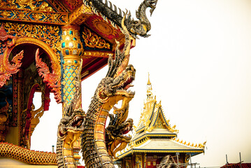 Fototapeta na wymiar Naga is a mythological creature in Buddhism to be sculpted into a statue Decorate the stairs, doors and roofs of temples. It is beautiful and awe-inspiring. This photo was taken at Wat Nam Khrok, Nan 