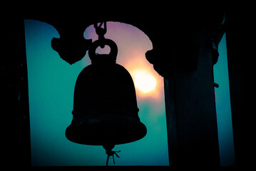 Silhouette of the bell tower in the temple . The bell is used to ring to tell the time.
This photo was taken at Wat Nam Krok, Nan Province. - obrazy, fototapety, plakaty