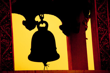 Silhouette of the bell tower in the temple . The bell is used to ring to tell the time.
This photo was taken at Wat Nam Krok, Nan Province. - obrazy, fototapety, plakaty