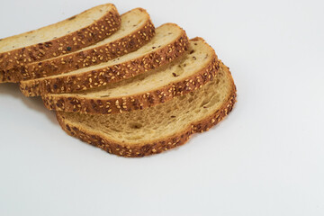 Sliced whole wheat bread on white background for cutting out.