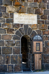 Wood door in the Roosevelt Arch on a bright sunny day, Yellowstone National Park, USA.

