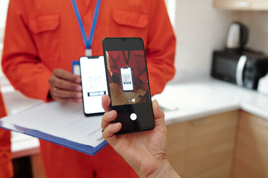 Hands Of Woman Scanning QR Code On Smartphone That Redirects On Website For Touch Free Payment