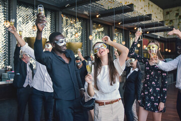Group people dancing and drink celebrate in mask party and happy new year party