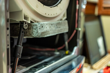 Selective Focus on the gasket mount of a front loading washing machine being serviced