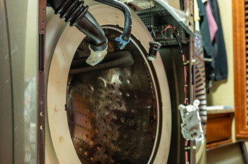 Selective Focus on the gasket mount of a front loading washing machine being serviced