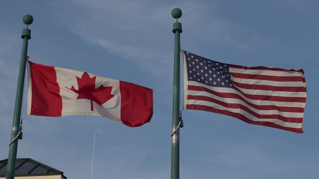 Canada flag and USA flag at custom crossing border united states of america free exchange
