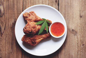 Crispy fried chicken food with cannabis leaf - marijuana leaves plant, Cannabis food nature herb...