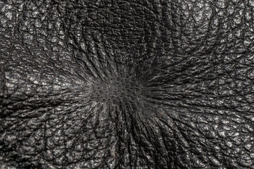 cigarette burn on a black, fake leather sofa, arm chair, furniture