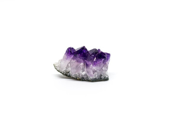 Crystal Stone macro, purple rough amethyst quartz crystals on white background.