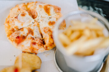 Fresh fried french fries with ketchup on wooden background