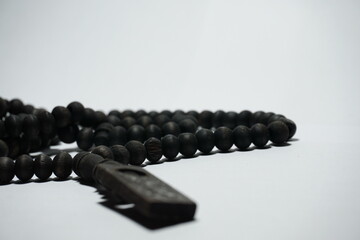 a tasbih that has a black color commonly used by Muslims, on a white background