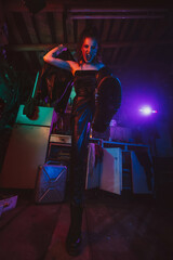 Obraz na płótnie Canvas Cyberpunk female cosplay with neon lighting. A girl in a steampunk costume