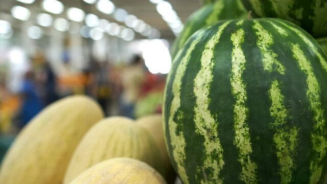 Fresh fruit market. Close up view of fresh-picked watermelons, melon and other food background. Slow motion