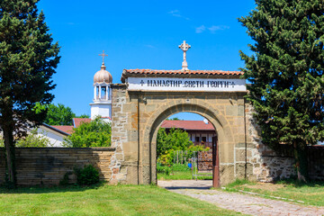 Fototapeta na wymiar Entrance gate of monastery of St. George in Pomorie, Bulgaria. Inscription on gate: Monastery of St. George