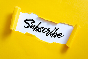 The word SUBSCRIBE appearing behind torn paper