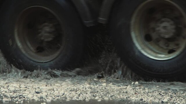 Very deep pits after rain, badly damaged road infrastructure. Cars drive slowly along the road with potholes and puddles. Asphalt in violation of technology. Taxpayer money is wasted. UHD 4K.