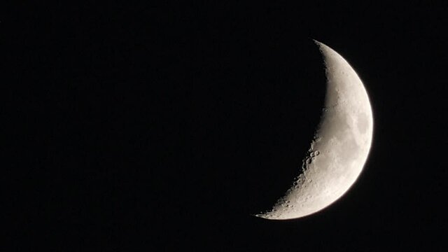 Close Up View Of Crescent Moon Slowly Moving Down At The Night Sky.