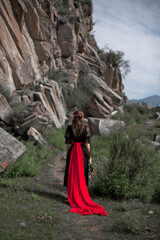 beautiful girl, brunette in a black dress with a red belt, photo session in the mountains, altai, red lips