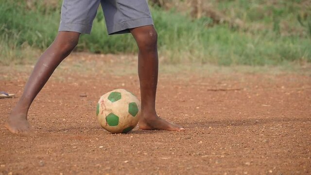 Kid Legs Playing Football In Africa