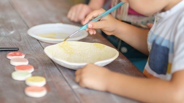 workshop for kids. Children learning how to use clay for making beautiful dishes. Workshop, master class.