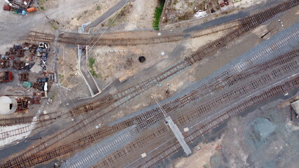 top down drone view of vintage railway tracks, sheds and an underground passageway