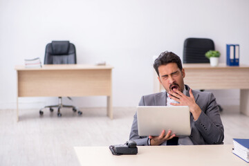 Young male employee working in the office