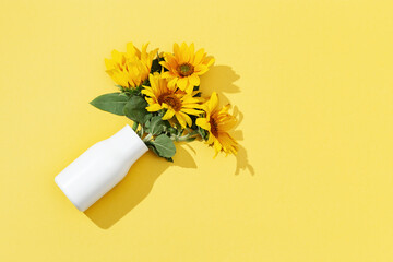Yellow sunflowers in white vase , view from above. Natural flowery background. Flat lay.