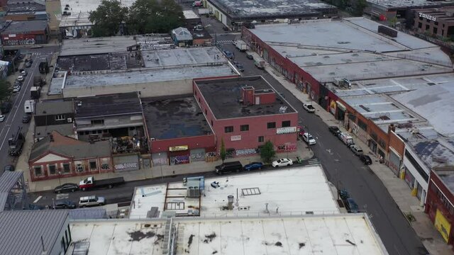 Quick and fast aerial flight over Brooklyn New York warehouse rooftops in the Bushwick neighborhood