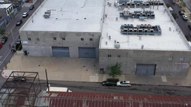 Quick aerial flight over industrial rooftops in Brooklyn New York
