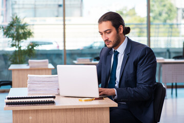 Young male employee working in the office