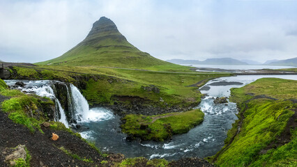 Bend of river and waterfalls cascade at mountain panorama near Olafsvik, Iceland